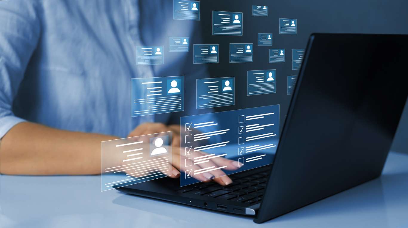 EOR vs PEO services: Human resources management employee working remotely on their laptop, with a floating digital overlay.