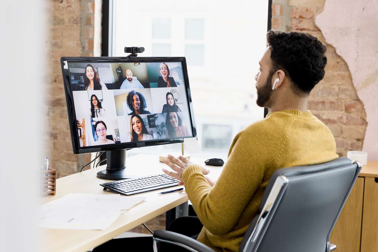 Meeting with remote teams - Man working at home having a meeting with his colleagues online.
