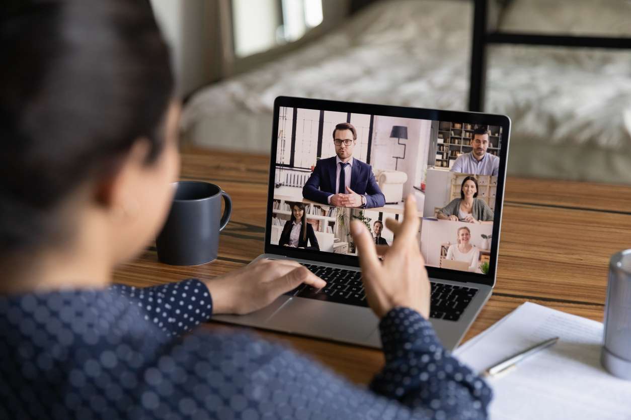 Managing remote teams - Woman having a meeting with her colleagues virtually.