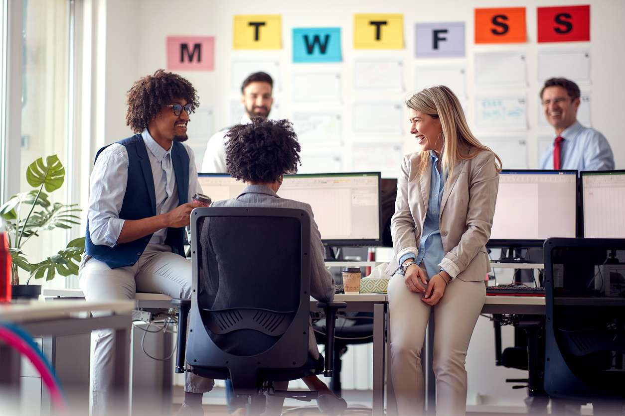 Retaining top talents - A female manager checking on her employees.