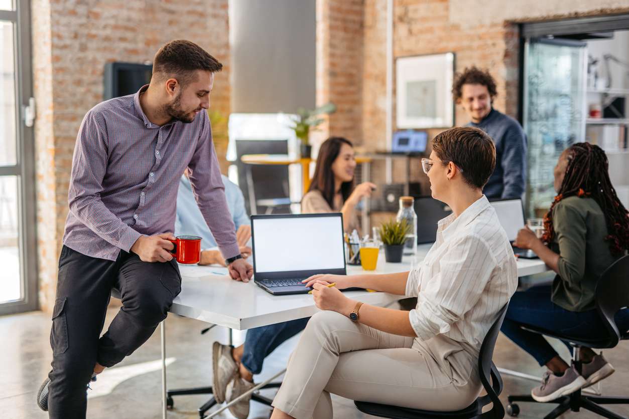Retaining top talents - A group of Gen Z employees working together in an office.