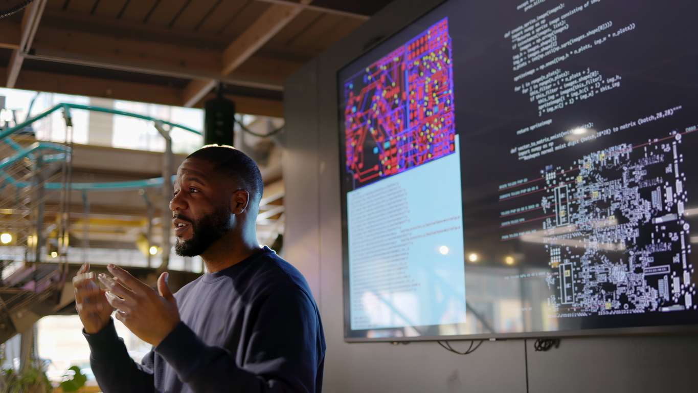 An IT personnel conducting a computer coding seminar for a tech company