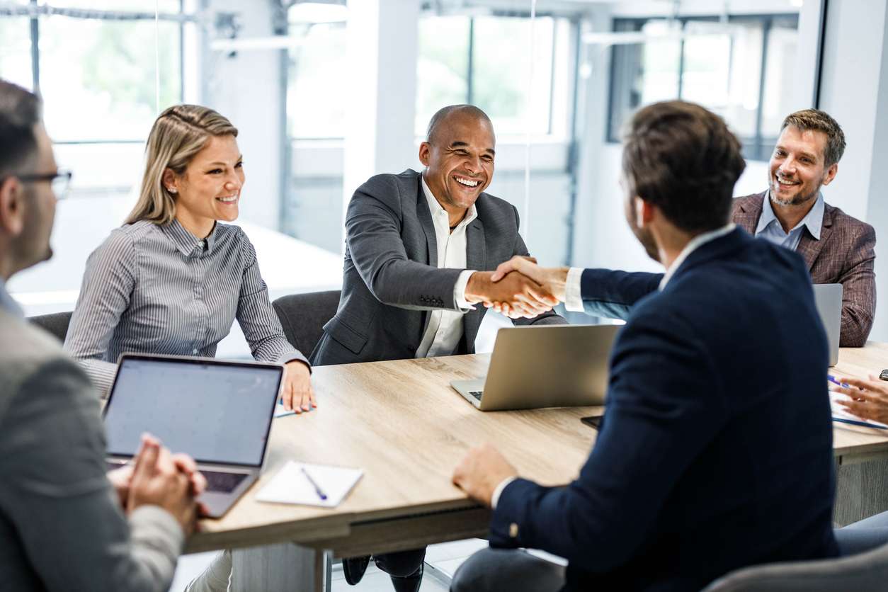 Choosing the right business partners. • BrightR Meeting business requirements - A group of business owners having a meeting in a conference room.