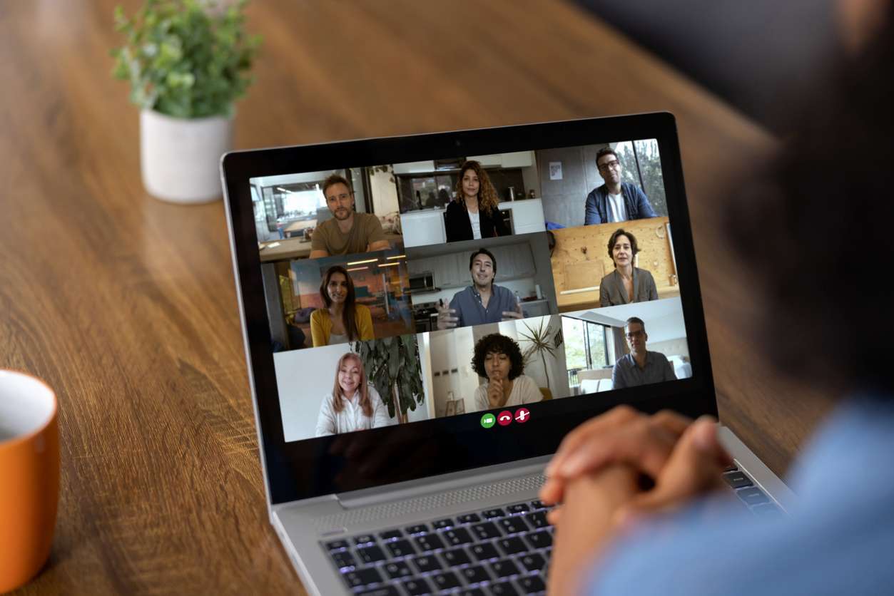 Improving your business's hiring solutions. • BrightR Business requirements for hiring - A businesswoman having a video conference meeting with her employees.