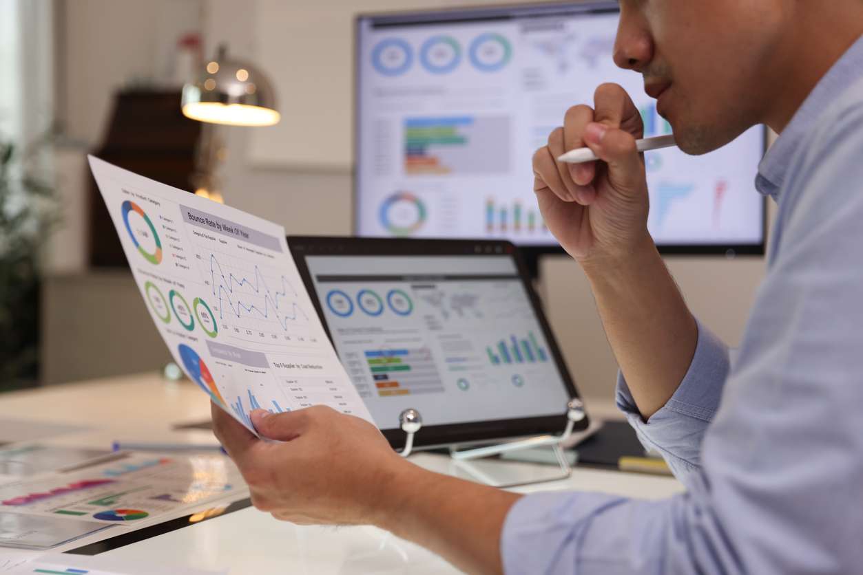 Global workforce management metrics - A businessman analyzing graphs to check for business performance.