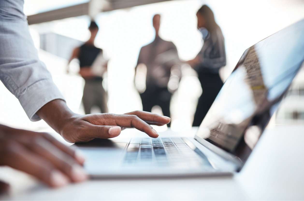 Managing a global workforce - A businessman using a laptop with installed software to manage global teams.