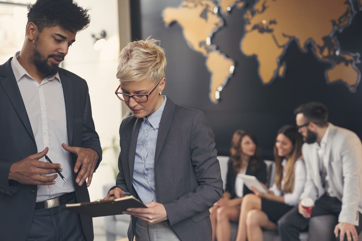 Cost-effectiveness of EOR services - Hiring managers reviewing employee resumes.