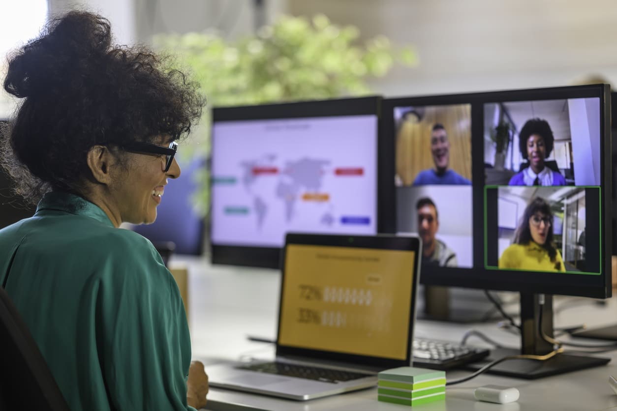 International business expansion strategies - A female employee having an online meeting with her colleagues while working remotely.