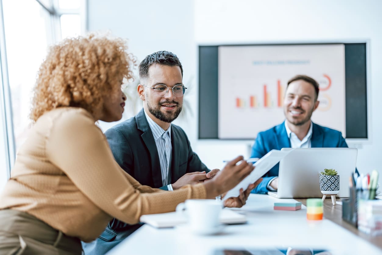 Business localization - A group of business owners discussing their business's performance during a meeting.