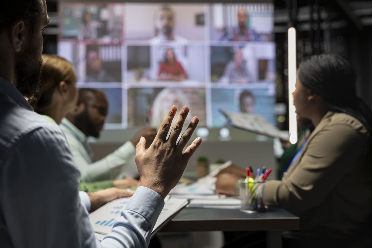 Team collaboration - A group of employees having a meeting with their colleagues virtually.