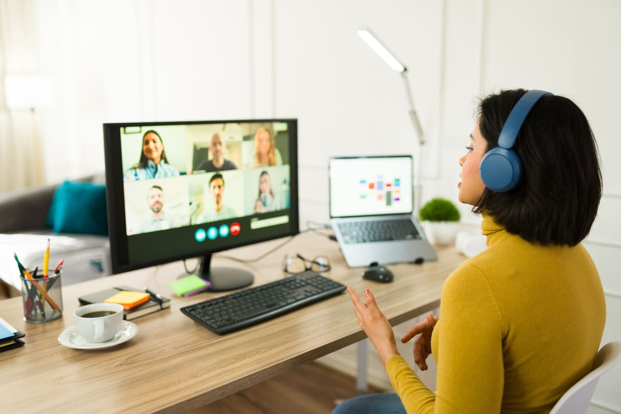 Work-from-home productivity - A woman at home having a virtual meeting with her colleagues.