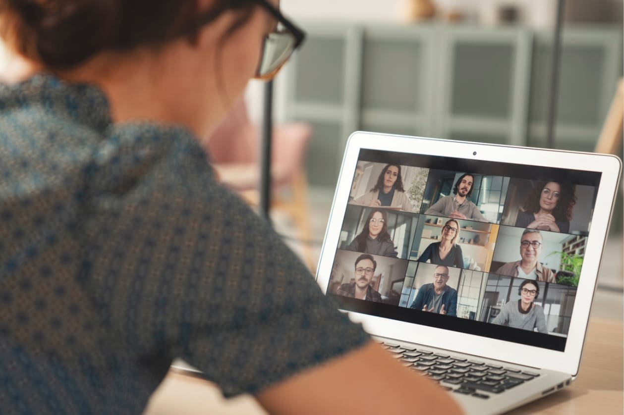Team collaboration - A woman working from home using her laptop to attend a virtual meeting.
