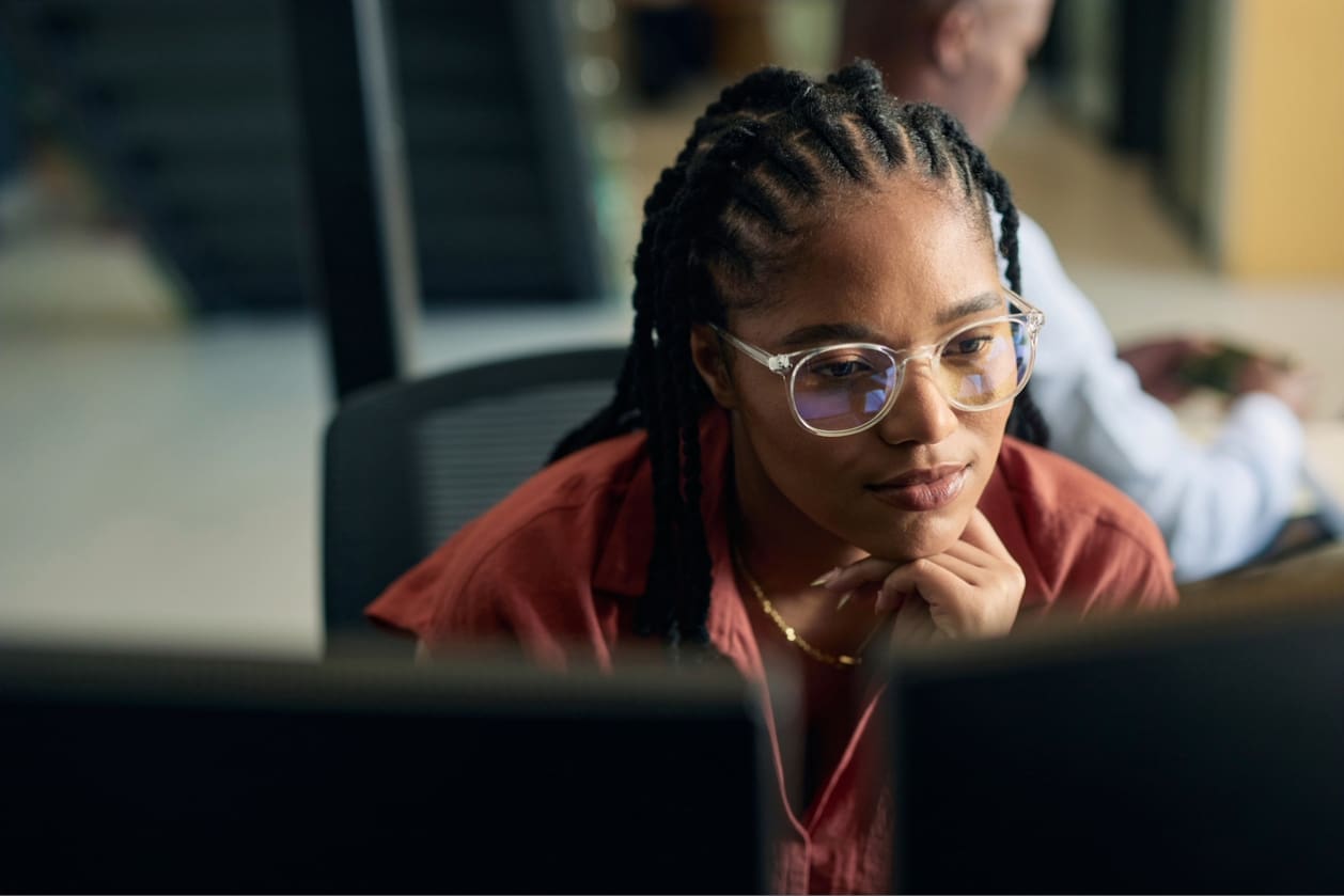 Employee engagement - A woman working in an office looking at her computer screen.