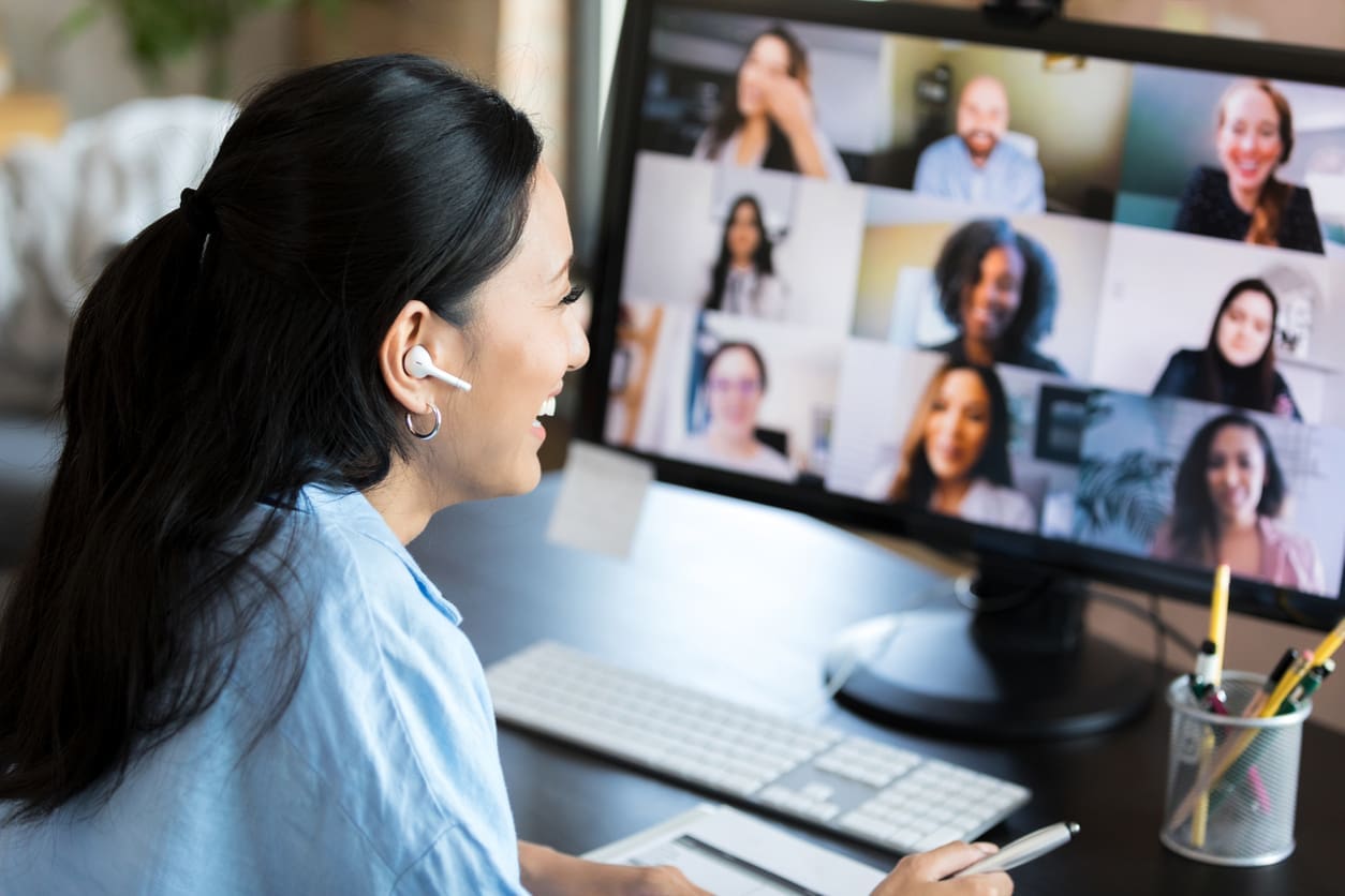 Employee retention strategies - A woman at home having a virtual meeting with her colleagues.