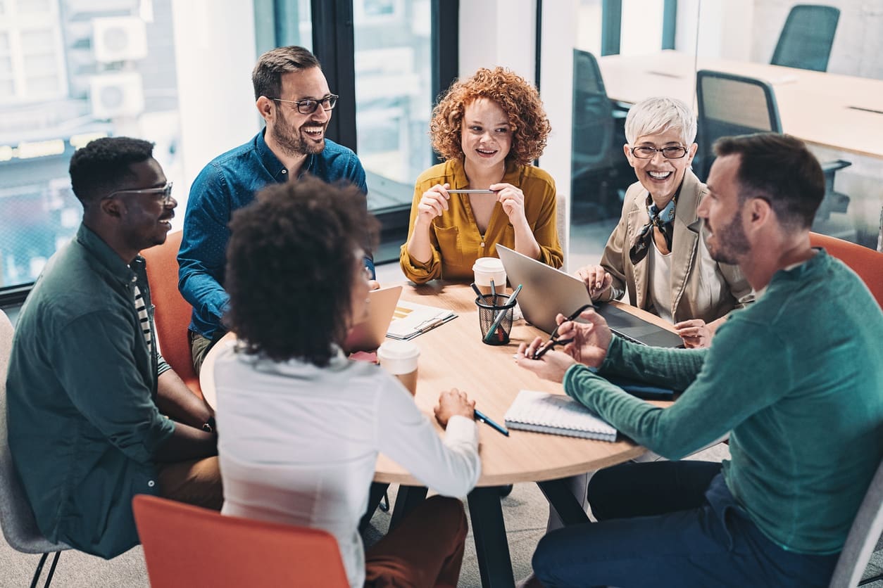 Employee engagement - A diverse group of employees in a meeting, discussing different workplace operations.