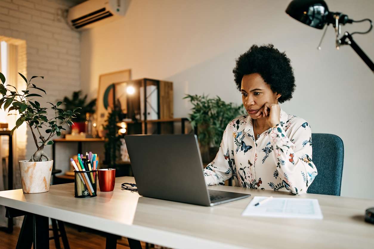 A woman performing remote work in her home office.
