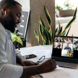 • BrightR Male employee having a zoom call with his co-employees