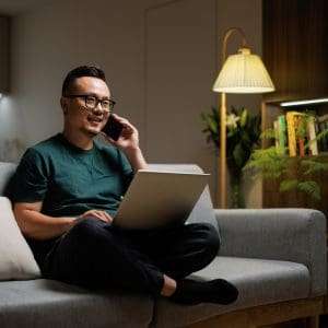 • BrightR Asian middle-aged white-collar workers use their phones to contact work at home