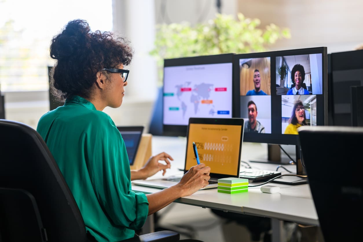 Strategizing with your internal remote teams - A woman brainstorming with her colleagues during a virtual meeting.