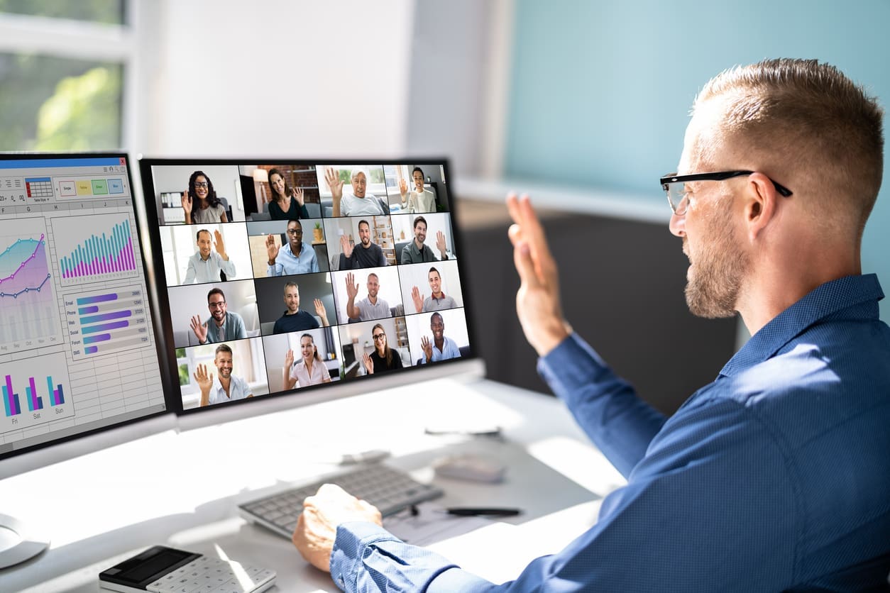 Remote team success strategies - A businessman having a virtual meeting with his employees working remotely.