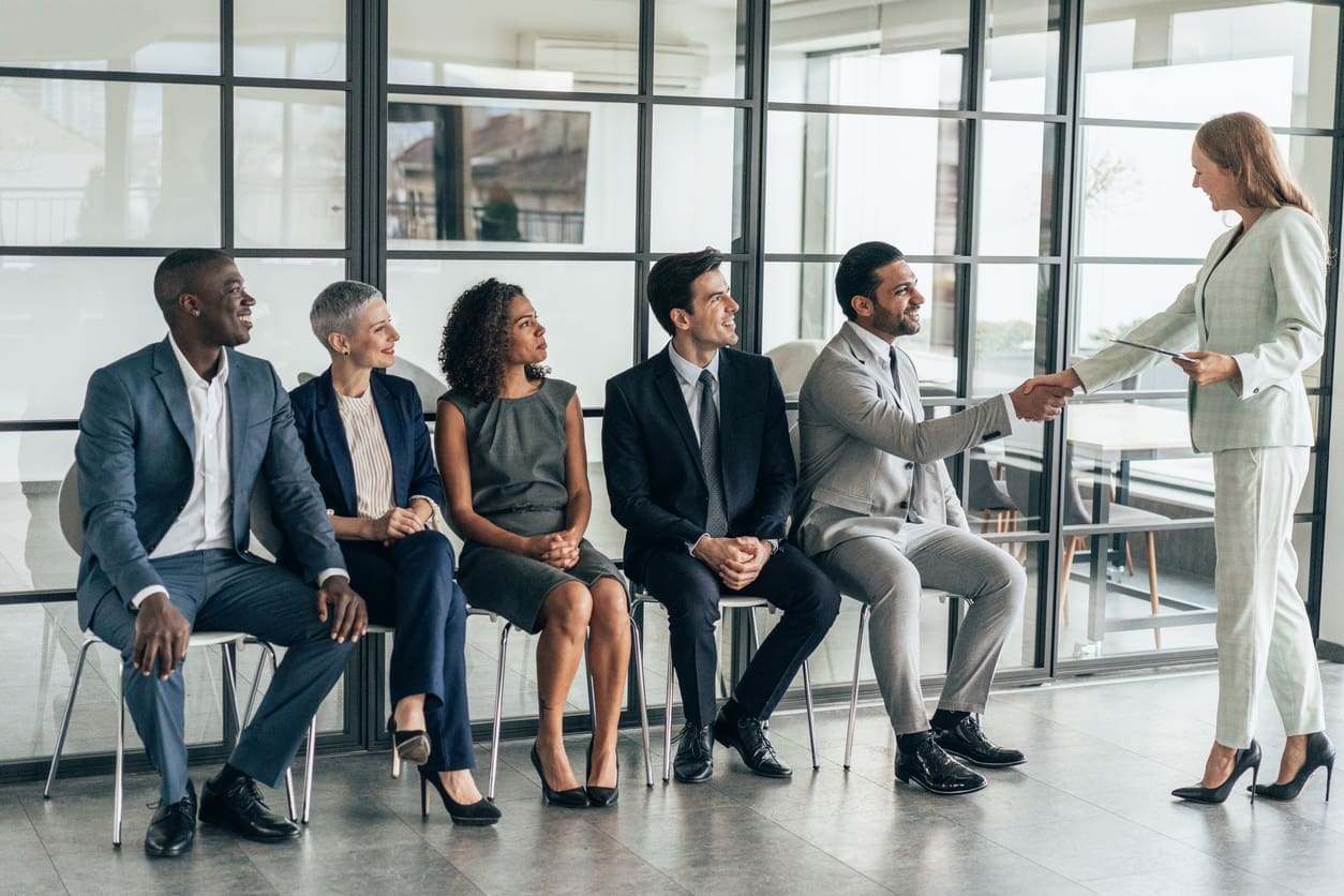 Scaling operations for your business - A businesswoman shaking hands with a prospective employee.