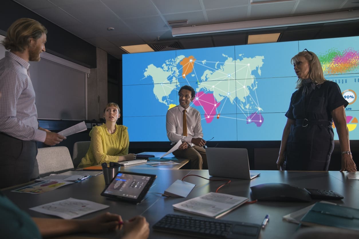 Business localization - A group of marketing professionals having a meeting in a conference room.